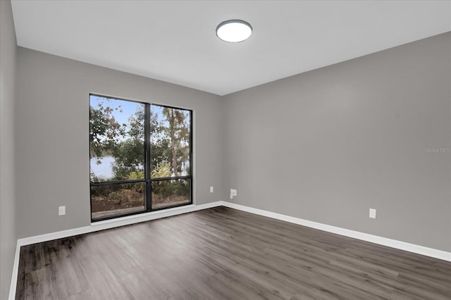 empty room with dark hardwood / wood-style floors