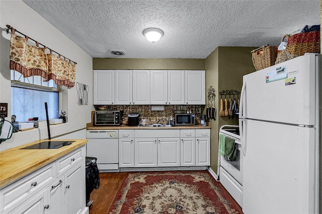 kitchen with white appliances, dark wood-type flooring, sink, tasteful backsplash, and white cabinetry