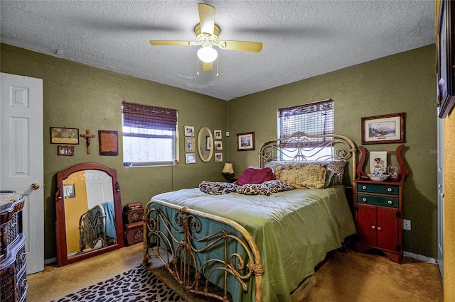 carpeted bedroom featuring ceiling fan and a textured ceiling