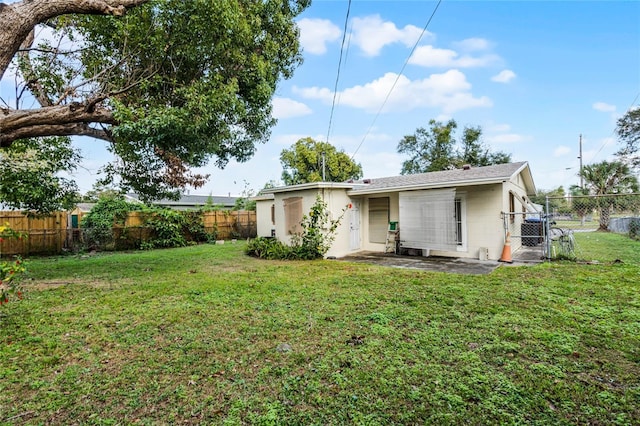 back of property with a lawn