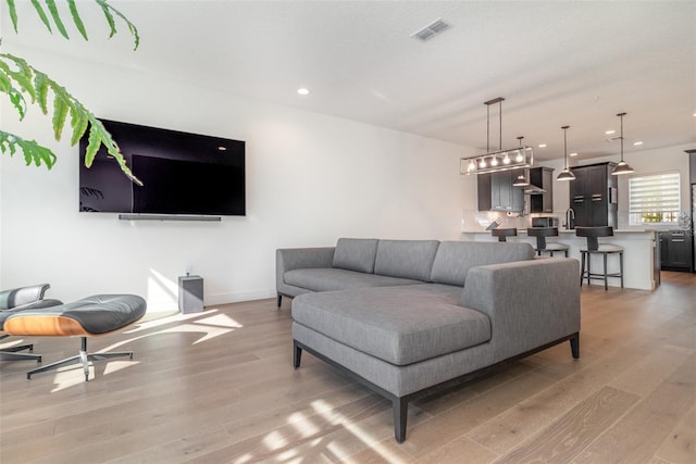 living room with light hardwood / wood-style floors