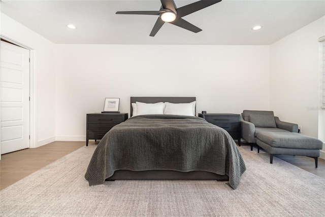 bedroom with ceiling fan and light hardwood / wood-style flooring