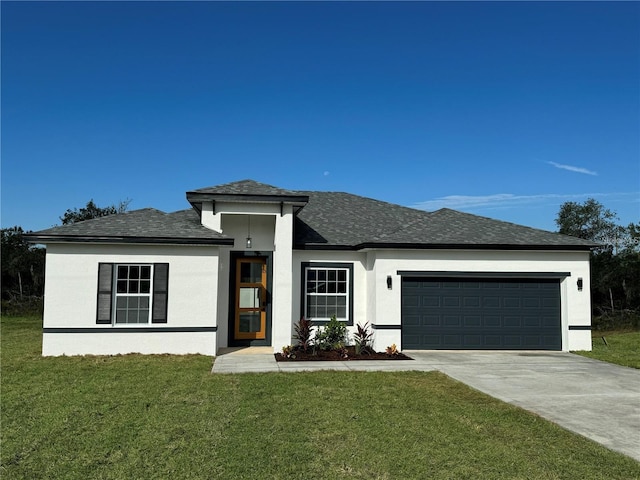 prairie-style house featuring a garage and a front lawn