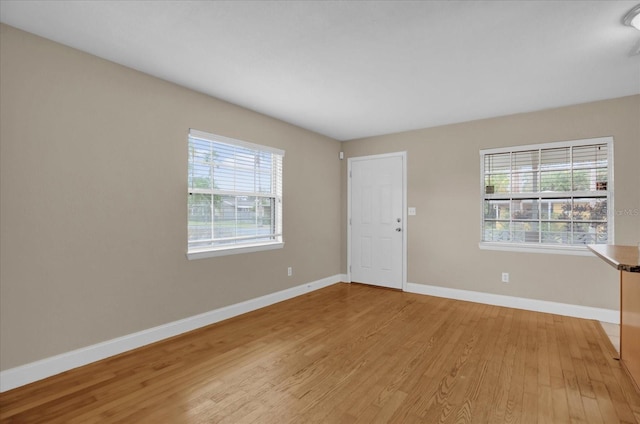 spare room with light hardwood / wood-style flooring