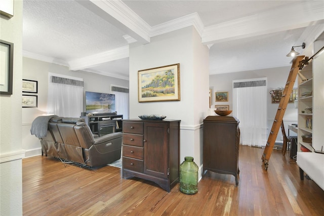 office with crown molding, beam ceiling, a textured ceiling, and light hardwood / wood-style flooring