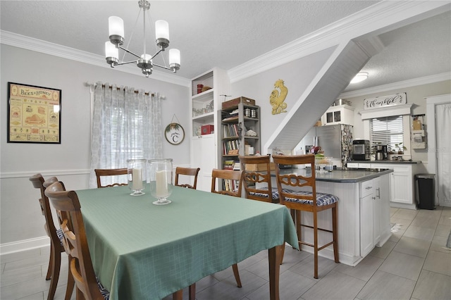 dining area featuring light tile patterned floors, ornamental molding, a chandelier, and a textured ceiling