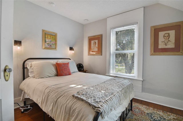 bedroom featuring wood-type flooring and vaulted ceiling