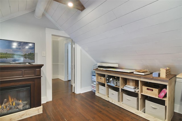 additional living space featuring dark hardwood / wood-style floors, vaulted ceiling with beams, wooden ceiling, and wooden walls