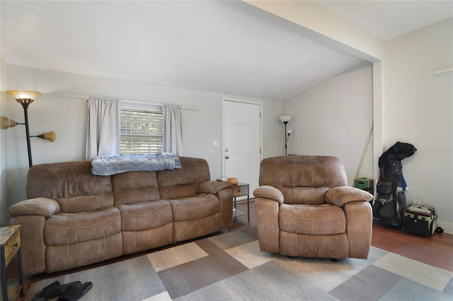 living room featuring hardwood / wood-style flooring and vaulted ceiling