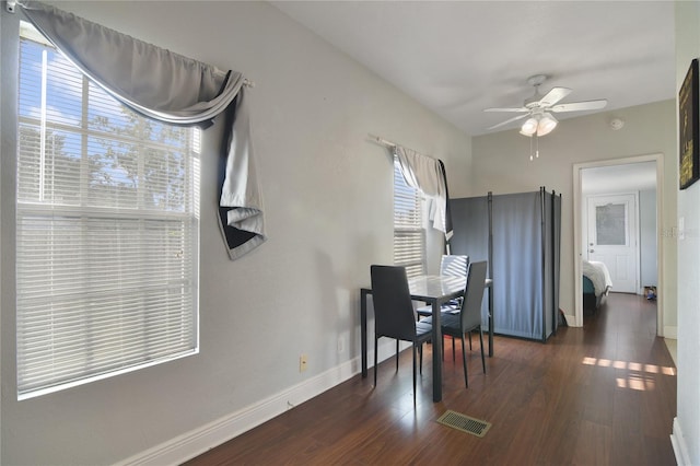 dining space with ceiling fan and dark hardwood / wood-style floors