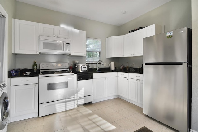 kitchen featuring white cabinetry, sink, white appliances, and light tile patterned floors