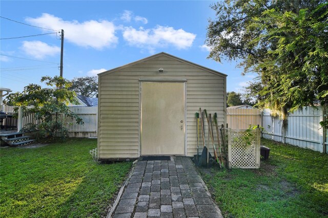 view of outbuilding with a yard