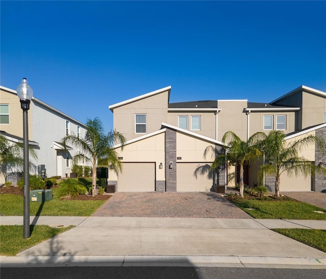 781 Ocean Course Ave Unit 601, Davenport, FL 33896 - view of front facade featuring decorative driveway, stucco siding, and a garage