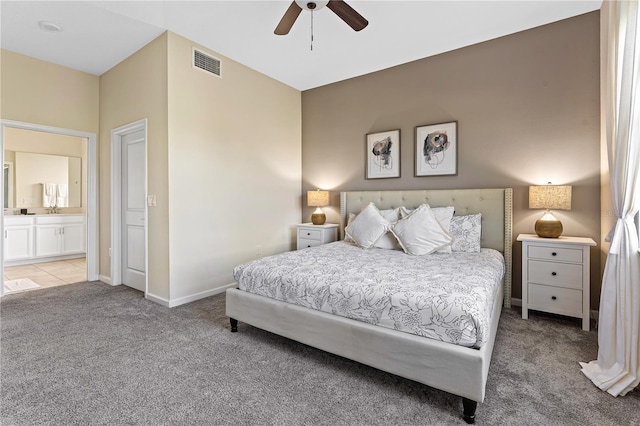 bedroom featuring ceiling fan, ensuite bathroom, and light carpet