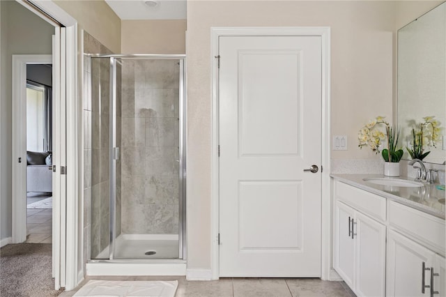 bathroom with tile patterned flooring, vanity, and an enclosed shower