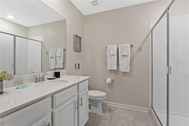 bathroom featuring tile patterned flooring, vanity, an enclosed shower, and toilet