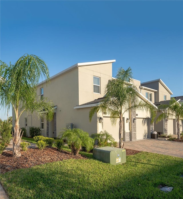 view of front of property with a front yard and a garage