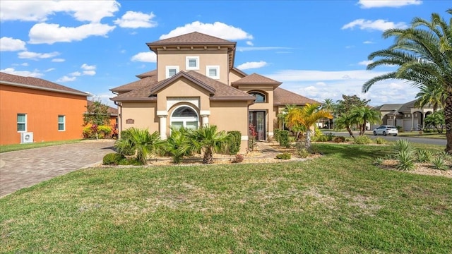 mediterranean / spanish home featuring a front yard