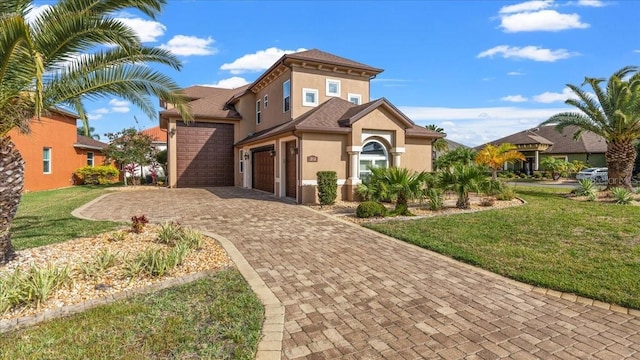 view of front of house featuring a garage and a front yard