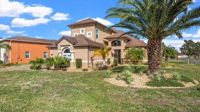 mediterranean / spanish home with a front yard