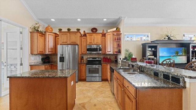 kitchen featuring backsplash, kitchen peninsula, sink, and appliances with stainless steel finishes