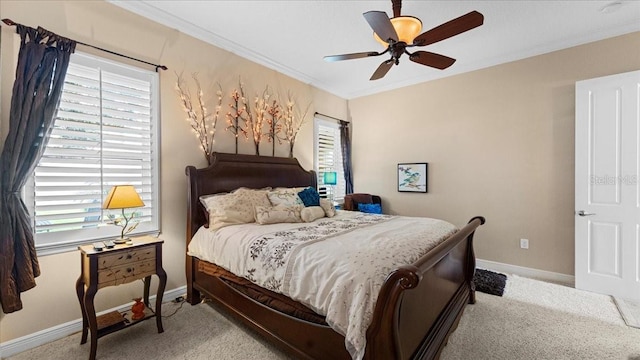 carpeted bedroom featuring ceiling fan and ornamental molding