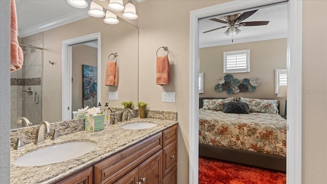 bathroom with ceiling fan, ornamental molding, a shower with door, and vanity