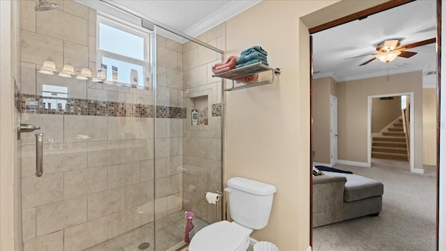 bathroom with toilet, a shower with door, ornamental molding, and ceiling fan