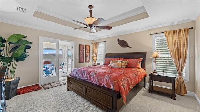 carpeted bedroom with ceiling fan, a raised ceiling, ornamental molding, and access to outside