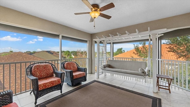 sunroom / solarium featuring ceiling fan