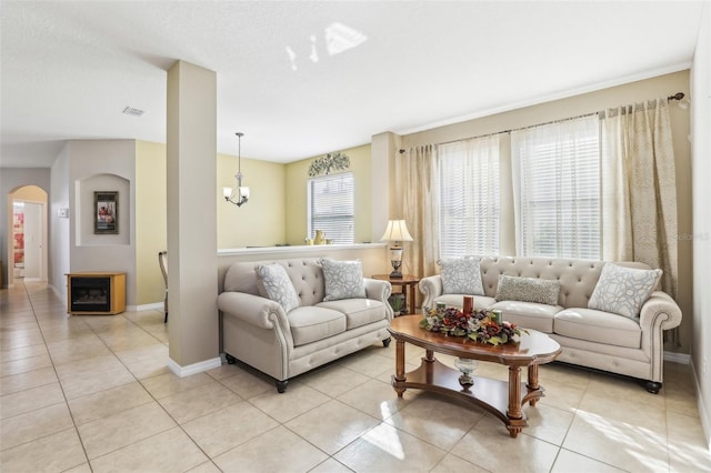 living room featuring a notable chandelier and light tile patterned flooring