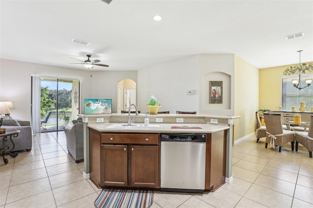 kitchen with pendant lighting, ceiling fan with notable chandelier, sink, stainless steel dishwasher, and light tile patterned flooring