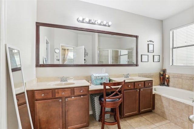 bathroom with tile patterned floors, vanity, and shower with separate bathtub