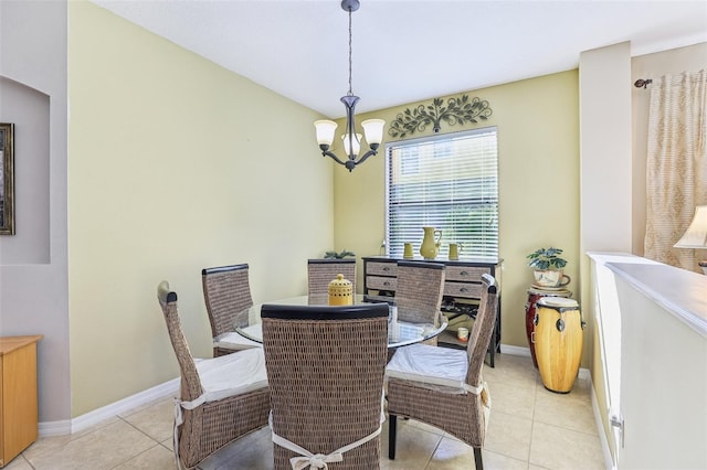 tiled dining room featuring an inviting chandelier