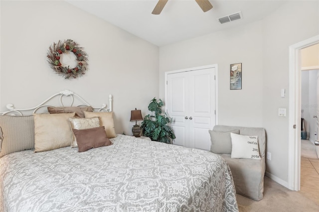 carpeted bedroom featuring ceiling fan and a closet