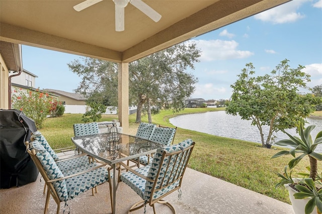 view of patio with a grill, ceiling fan, and a water view