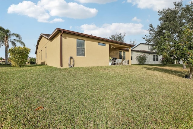 back of property featuring a yard