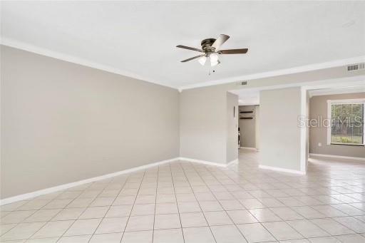 empty room with ceiling fan and ornamental molding