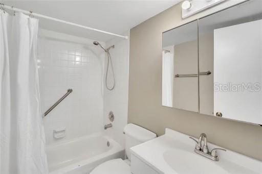 full bathroom featuring vanity, toilet, and shower / bath combo with shower curtain