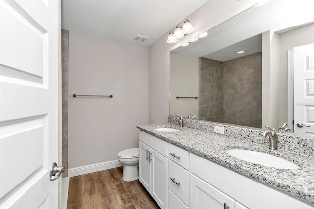 bathroom with hardwood / wood-style floors, toilet, and vanity