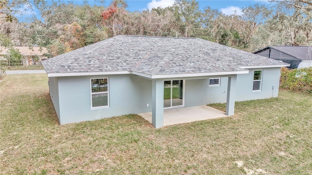 rear view of house with a patio area and a yard