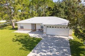 ranch-style home with a garage and a front yard