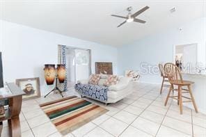 living room featuring ceiling fan and light tile patterned floors