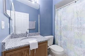 bathroom featuring vanity and toilet