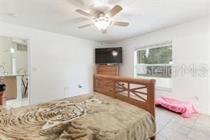 tiled bedroom with ceiling fan