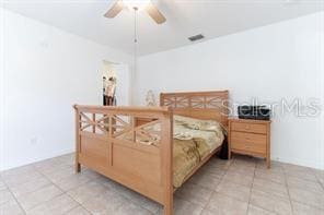 tiled bedroom with ceiling fan