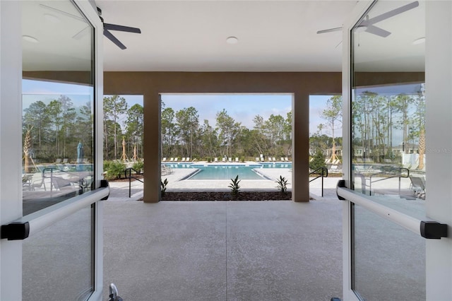 exterior space with a community pool and ceiling fan