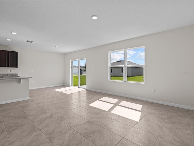 unfurnished living room featuring light tile patterned floors