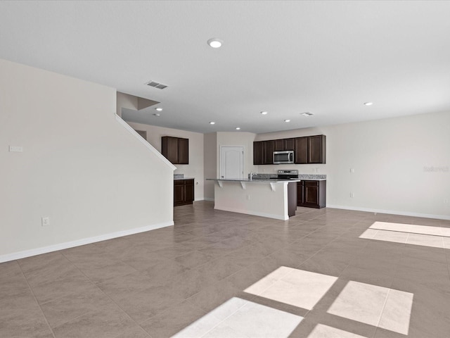 unfurnished living room featuring light tile patterned flooring