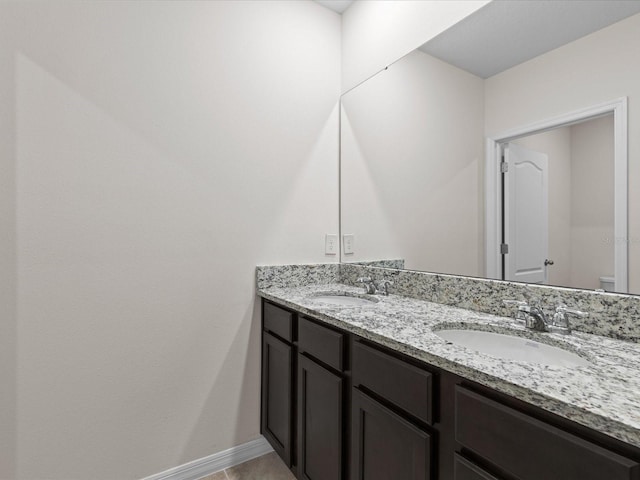 bathroom featuring tile patterned floors, vanity, and toilet